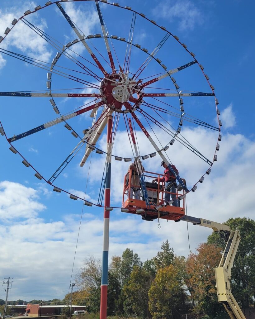 Conservationists on lift, putting panels back on Milkshake America